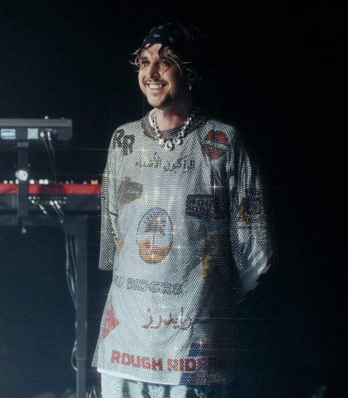 Oscar and the wolf leader max colombie standing while smiling in the backstage